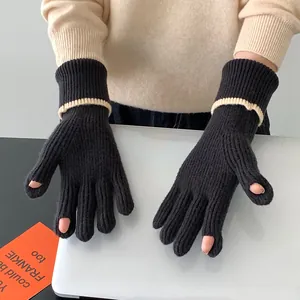Detail showing knitted texture and split-finger design of black winter gloves