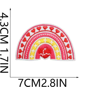Detailed size diagram of a rainbow heart embroidered patch showing 7cm x 4.3cm dimensions