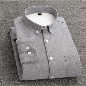 Close-up of a premium folded grey Oxford shirt featuring a warm white fleece lining.