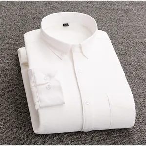 Detailed view of a folded white Oxford shirt with button-down collar on gray background
