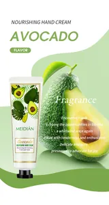 Detail of nourishing avocado hand cream tube displayed with fresh avocado fruit slices