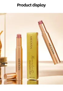 Professional detail shot of shimmer gradient eyeshadow sticks with premium gold packaging