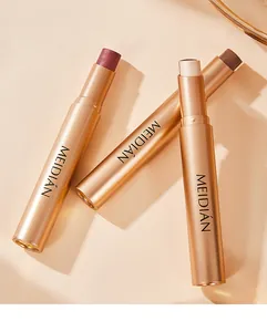 Detail view of three metallic gold eyeshadow sticks in various pearlescent and matte shades