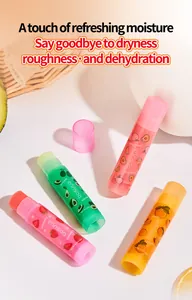Set of four colorful fruit lip balms with strawberry, avocado, peach, and orange scents.