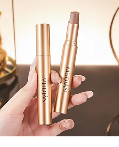 Close-up detail of MEIDIÁN shimmer eyeshadow stick in luxury champagne gold case