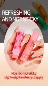 Detailed close-up view of Bosuya fruit flavored lip balms held in hand, smooth texture