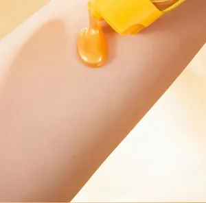 Macro detail of golden pearlescent peel-off mask texture being applied to the skin surface