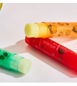 Detailed macro view of Bosuya fruit lip balm sticks with orange and watermelon scents