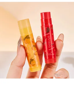 Close-up of bosuya orange and watermelon flavored lip balms held in hand