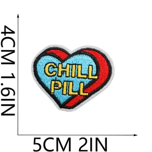 Detailed view of a heart embroidered patch with Chill Pill text showing exact dimensions