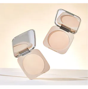 Macro view of lightweight matte setting powder in open nude-colored compact with mirror.