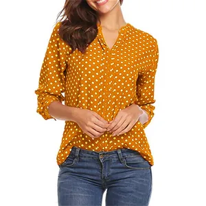 Detailed view of women's mustard yellow polka dot V-neck blouse with long sleeves