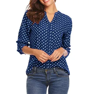 Detail shot of women's blue polka dot V-neck blouse with adjustable long sleeves