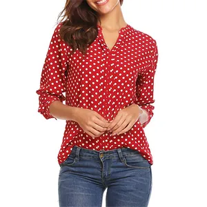 Close-up showing the red polka dot pattern and V-neck design of the loose-fit blouse