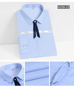 Details of light blue women's dress shirt showing fabric texture and buttons
