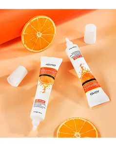 Detailed macro view of ADMD Vitamin C eye cream tubes with fresh orange slices props