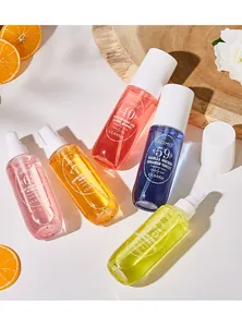 Collezione di flaconi di profumo spray ADMD colorati con fette di arancia decorative