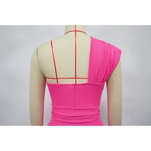 Close-up back view of hot pink one-shoulder dress with invisible zipper detail