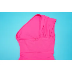 High-quality detail shot of pink one-shoulder dress showing invisible zipper and waist design