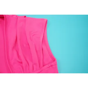 Close-up detail showing pink pleated shoulder design and fine stitching on summer dress