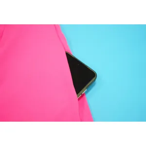 Close-up detail shot of the functional side pocket on a vibrant pink flared fashion dress