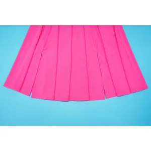 Close-up of vibrant pink pleated dress hem showing clear fabric texture and stitching
