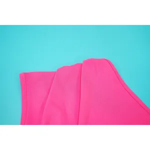 Close-up view of the bright pink fabric and stitching detail on an elegant summer dress.