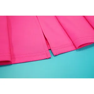 Close-up of fine stitching and vibrant pink fabric texture on a summer dress.