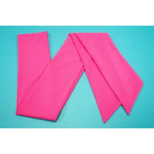 Vibrant fuchsia fabric waist sash belt accessory detail shown on a cyan background