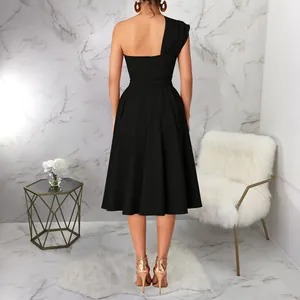Detail view of black one-shoulder midi dress with cinched waist and large swing skirt