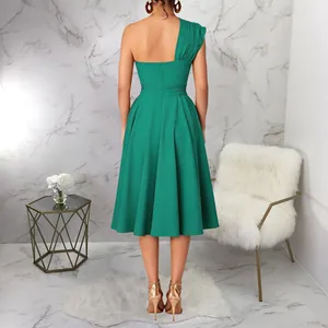 Back view of a vibrant green one-shoulder dress featuring a waist-cinching A-line skirt