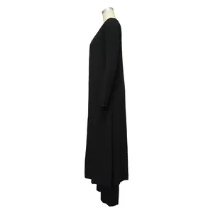 Side view detail of a black ribbed knit long-sleeved dress from a three-piece set.