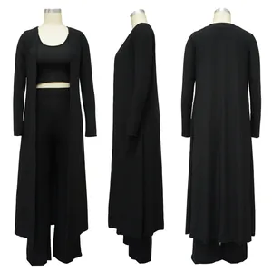 Three-piece black ribbed knit set with long cardigan, crop top and wide-leg pants.
