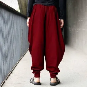 Back view of loose men's harem pants in wine red, featuring a tapered lantern silhouette.