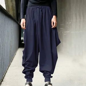 Detailed shot of men's loose navy blue harem pants featuring a vintage lantern design
