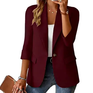 Close-up detail of women's burgundy three-quarter sleeve blazer jacket on model