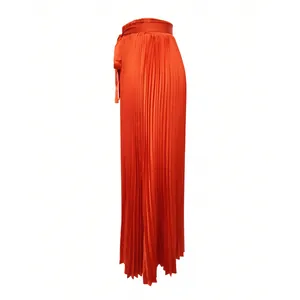 High-waisted vibrant orange pleated maxi skirt featuring a smooth faux silk satin texture
