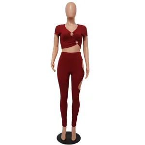 Detailed view of women's two-piece set featuring V-neck crop top and side cut-out leggings