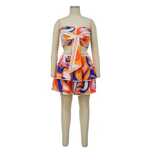 Detailed view of vibrant orange and blue geometric print two-piece tube top skirt set