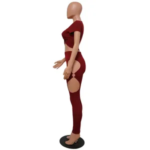 Side view of two-piece burgundy ribbed set with cut-out pants and ring detail