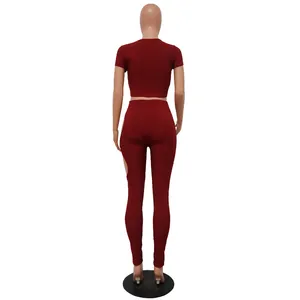 Detailed back view of a burgundy ribbed two-piece set with crop top and leggings