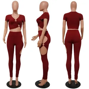 Detailed view of burgundy two-piece set with V-neck top and side cutout leggings
