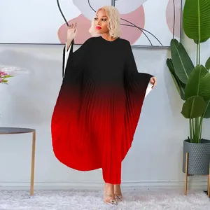 Detailed view of the black to red gradient pleated texture on this batwing sleeve dress