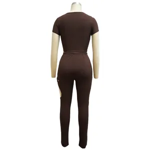 Back view of brown two-piece ribbed set featuring crop top and cutout leggings detail.