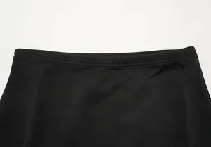 Detailed close-up of the elasticated waistband on a black high-low fishtail skirt