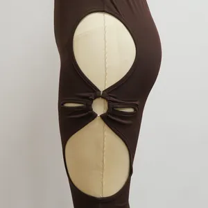 Detail of brown ribbed set showing side cut-out design with gold metal ring connector.