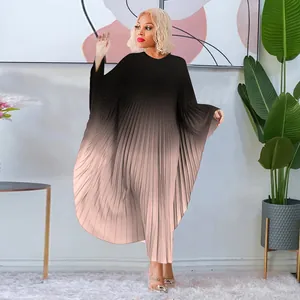 Close-up view of pleated gradient batwing sleeve dress showing fabric texture and drape.