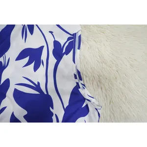 Detailed close-up showing the blue floral print fabric and high-quality stitching detail.