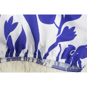 Close-up macro view of the elasticated hemline on blue floral print trousers for women