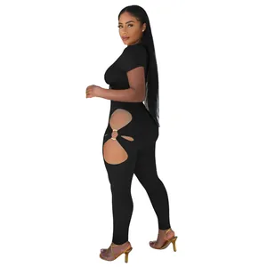 Side view showing the detailed cutout and gold ring link on the black high-waisted pants